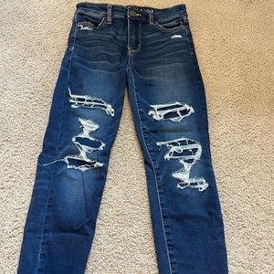 blue patched distressed american eagle jeans.